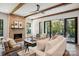 Cozy living room with a brick fireplace, plush seating, and access to the balcony at 5610 Farmbrook Dr, Charlotte, NC 28210