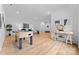 Spacious living room featuring a foosball table, light hardwood floors, and stylish modern decor at 5610 Farmbrook Dr, Charlotte, NC 28210