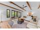 Bright living room with modern decor, wood beams, fireplace, and sliding doors to a balcony at 5610 Farmbrook Dr, Charlotte, NC 28210