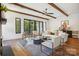 Bright living room featuring exposed beams, modern furniture, and a view of the outdoor landscape at 5610 Farmbrook Dr, Charlotte, NC 28210