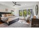 Serene main bedroom with natural light, hardwood floors, and modern furnishings at 5610 Farmbrook Dr, Charlotte, NC 28210