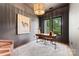 Stylish home office with modern lighting, a large desk, and a view of nature at 5610 Farmbrook Dr, Charlotte, NC 28210