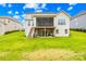 Well-maintained backyard with a covered porch, steps to the yard, and lush green grass at 6022 Candlestick Ln, Lancaster, SC 29720