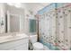 Bathroom features a sink vanity, toilet, and a shower with a blue curtain at 6022 Candlestick Ln, Lancaster, SC 29720