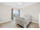 Bright bedroom with carpet flooring features a white queen bed and a window at 6022 Candlestick Ln, Lancaster, SC 29720