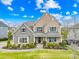 Beautifully landscaped front yard with a charming two-story home featuring stone and shingle accents and a welcoming entryway at 6022 Candlestick Ln, Lancaster, SC 29720