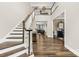Grand foyer featuring hardwood floors, staircase with white railings, and views into the living and dining spaces at 6022 Candlestick Ln, Lancaster, SC 29720