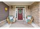 Inviting front porch with seating, a wreath on the door, and beautiful stone accents creates a welcoming entrance at 6022 Candlestick Ln, Lancaster, SC 29720