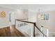 Hallway overlooking grand foyer with high ceilings, hardwood floors, staircase, and modern lighting fixture at 6022 Candlestick Ln, Lancaster, SC 29720