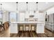 Open-concept kitchen featuring white cabinets, marble countertops, and pendant lighting at 6022 Candlestick Ln, Lancaster, SC 29720