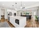 Open-concept kitchen with a large island, stainless steel appliances, and seamless flow to the living room at 6022 Candlestick Ln, Lancaster, SC 29720