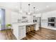 Modern kitchen featuring white cabinets, stainless steel appliances, large island and hardwood floors at 6022 Candlestick Ln, Lancaster, SC 29720