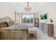 Elegant main bedroom featuring a decorative chandelier, large windows, and stylish furnishings at 6022 Candlestick Ln, Lancaster, SC 29720