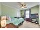 Comfortable bedroom featuring a ceiling fan, neutral carpet, large window, and closet for easy storage at 6523 Matlea Ct, Charlotte, NC 28215