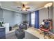 Relaxing bedroom with a comfortable recliner, fan, and light-blocking curtains at 6523 Matlea Ct, Charlotte, NC 28215