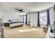 Bright and airy bedroom with neutral tones, large windows, and a ceiling fan, creating a comfortable and relaxing retreat at 6523 Matlea Ct, Charlotte, NC 28215