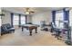 Spacious bonus room with a pool table, desk, and ample natural light, creating a versatile and inviting space at 6523 Matlea Ct, Charlotte, NC 28215