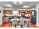 Eat-in kitchen featuring wood cabinetry, stainless steel appliances, and ample counter space at 6523 Matlea Ct, Charlotte, NC 28215
