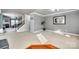 Spacious living room featuring plush carpeting, crown molding, and an open staircase at 6523 Matlea Ct, Charlotte, NC 28215