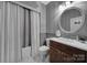 Chic bathroom with a modern vanity, decorative mirror, and tiled shower for a spa-like experience at 705 Drew Ave, Fort Mill, SC 29708