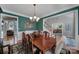 Inviting dining room with rich green walls, wood trim, and a view of the staircase and living spaces at 705 Drew Ave, Fort Mill, SC 29708