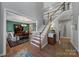 Elegant foyer with hardwood floors, a staircase with white railings, and a view of the formal dining room at 705 Drew Ave, Fort Mill, SC 29708