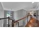 Upstairs hallway features hardwood floors, natural light and leads to the bedrooms at 705 Drew Ave, Fort Mill, SC 29708