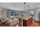 Open concept kitchen with a large island, pendant lighting, hardwood floors, and natural light at 705 Drew Ave, Fort Mill, SC 29708