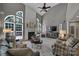 Bright living room featuring high ceilings, a fireplace, large windows, and modern decor at 705 Drew Ave, Fort Mill, SC 29708