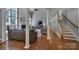 Well-lit living room showcasing hardwood floors, fireplace, and an open layout with staircase access at 705 Drew Ave, Fort Mill, SC 29708