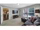 Spacious living room with plush seating, a large TV, and natural light from two large windows at 705 Drew Ave, Fort Mill, SC 29708