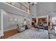 Open-concept living room with hardwood floors, stylish furniture, and seamless flow to the kitchen at 705 Drew Ave, Fort Mill, SC 29708