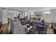 Open concept living room with hardwood floors, comfortable seating, and view of the kitchen at 705 Drew Ave, Fort Mill, SC 29708
