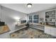 Bright office features built-in desk, large window and wood floors covered by a colorful floral rug at 705 Drew Ave, Fort Mill, SC 29708
