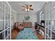 Bright home office featuring hardwood floors, a comfortable leather chair, and an elegant arched window at 705 Drew Ave, Fort Mill, SC 29708