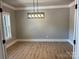 Clean dining room with hardwood floors, neutral paint, with a modern light fixture at 7221 Static Way # 13, Sherrills Ford, NC 28673