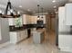 Modern kitchen featuring white cabinets, stainless steel appliances, and a central island for cooking and entertaining at 7221 Static Way # 13, Sherrills Ford, NC 28673