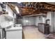 Unfinished basement featuring utility sink, wood-burning furnace and exposed ductwork, offering potential for customization at 7270 Long Island Rd, Catawba, NC 28609