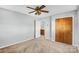 Neutral bedroom featuring light gray walls, plush carpeting, closet, and a ceiling fan with a decorative light fixture at 7270 Long Island Rd, Catawba, NC 28609
