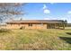 Long ranch-style home with a metal roof, brick exterior, side carport, and a sprawling backyard with vibrant green grass at 7270 Long Island Rd, Catawba, NC 28609