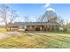 Traditional-style brick home with a covered parking area and well-maintained lawn, radiating warmth at 7270 Long Island Rd, Catawba, NC 28609