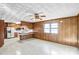 Cozy open living space with wood-paneled walls and a large window with a kitchen area and vinyl floors at 7270 Long Island Rd, Catawba, NC 28609