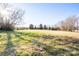 Expansive grassy lot showcasing open space, mature trees and sunlight, offering ample possibilities for outdoor activities at 7270 Long Island Rd, Catawba, NC 28609