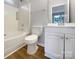 Bright bathroom with a shower-tub combo and updated vanity at 7926 Sir Barton Ct, Charlotte, NC 28215