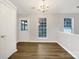 Cozy dining area features hardwood floors, updated lighting, and a bright view from the windows at 7926 Sir Barton Ct, Charlotte, NC 28215