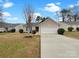 Charming single-story home with a well-maintained lawn, complemented by an attached single-car garage and blue shutters at 7926 Sir Barton Ct, Charlotte, NC 28215