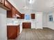 Bright kitchen features dark wood cabinetry, white appliances, and a window above the sink, offering a functional layout at 7926 Sir Barton Ct, Charlotte, NC 28215