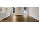 Open living space features hardwood floors and lots of natural light from large double windows at 7926 Sir Barton Ct, Charlotte, NC 28215