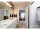 Bright bathroom boasts double sink vanity and walk-in shower, with bedroom and closet access at 8568 Windsor Ridge Dr, Charlotte, NC 28277