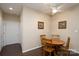 Dining area features hardwood floors, a ceiling fan, and a wooden table with chairs. Neutral wall color. Two framed photos at 8568 Windsor Ridge Dr, Charlotte, NC 28277